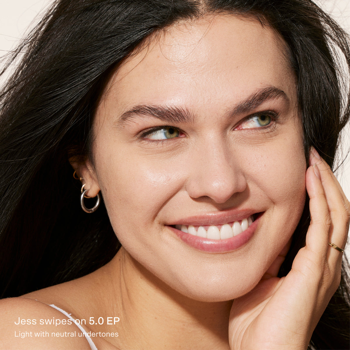 Close-up of a woman with a soft smile, wearing minimal makeup. [5.0 EP]