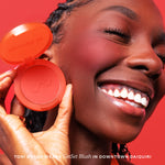 Woman holding a red blush compact with a red background [Downtown Daiquiri x Toni Bravo]