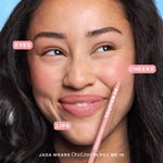 A person wearing the Tower 28 Beauty OneLiner in the shade Fill Me In on her lips, cheeks, and eyes. [Fill Me In]