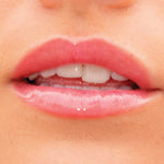 A model wearing the Tower 28 Beauty ShineOn Lip Jelly in the shade Coconut on her lips. [Coconut]