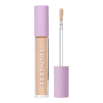 Tower 28 Beauty Swipe Serum Concealer in the shade 6.0 IE, shown with the tube standing upright next to the open applicator wand to reveal the product. [6.0 IE]