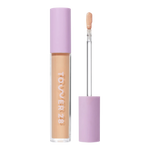Tower 28 Beauty Swipe Serum Concealer in the shade 7.0 KTOWN, shown with the tube standing upright next to the open applicator wand to reveal the product. [7.0 KTOWN]
