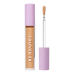Tower 28 Beauty Swipe Serum Concealer in the shade 11.0 OC, shown with the tube standing upright next to the open applicator wand to reveal the product. [11.0 OC]