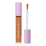 Tower 28 Beauty Swipe Serum Concealer in the shade 14.0 PV, shown with the tube standing upright next to the open applicator wand to reveal the product. [14.0 PV]