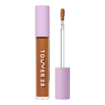 Tower 28 Beauty Swipe Serum Concealer in the shade 15.0 SAMO, shown with the tube standing upright next to the open applicator wand to reveal the product. [15.0 SAMO]